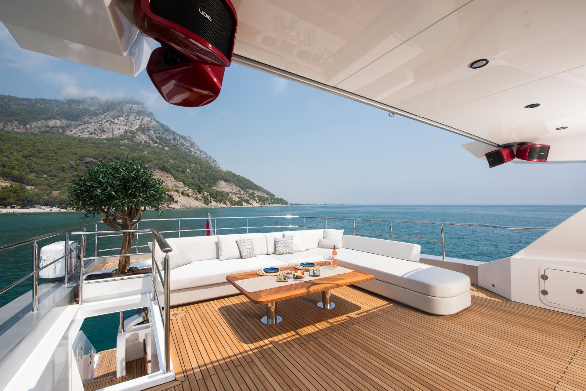 Upper deck seating with olive tree and open sea